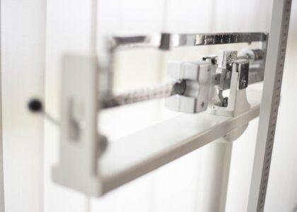 A mechanical scale designed for weighing dogs, featured in a bright setting.