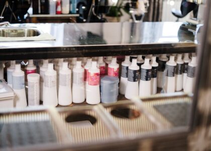 A variety of dog conditioners lined up on a shelf, relevant to dog conditioner reviews.