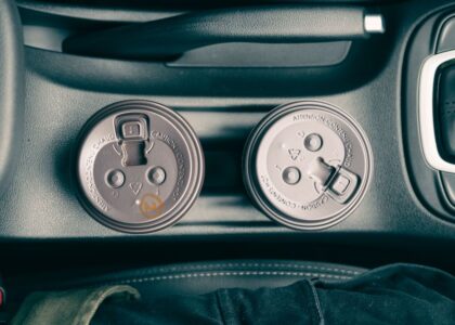Two travel dog water bowls placed in car cup holders, ideal for road trips.