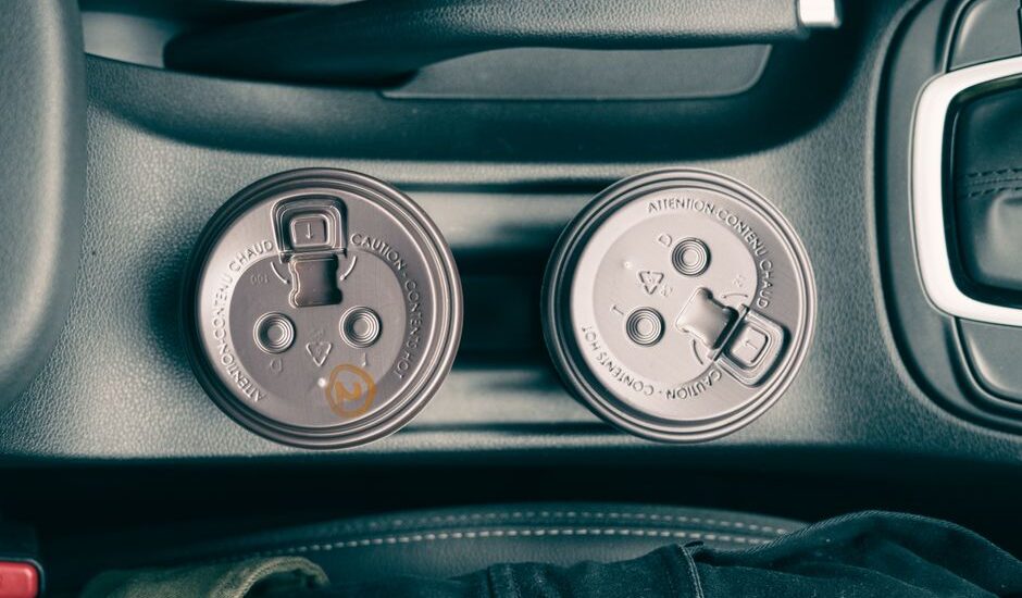 Two travel dog water bowls placed in car cup holders, ideal for road trips.